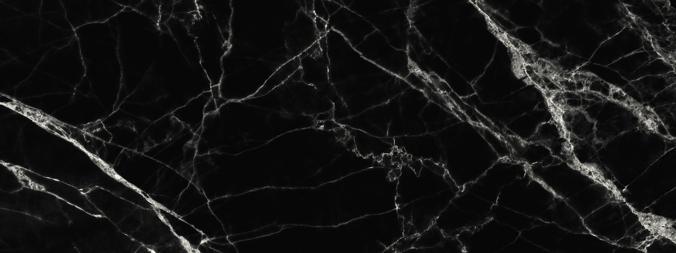 Black marble texture with white veining pattern.