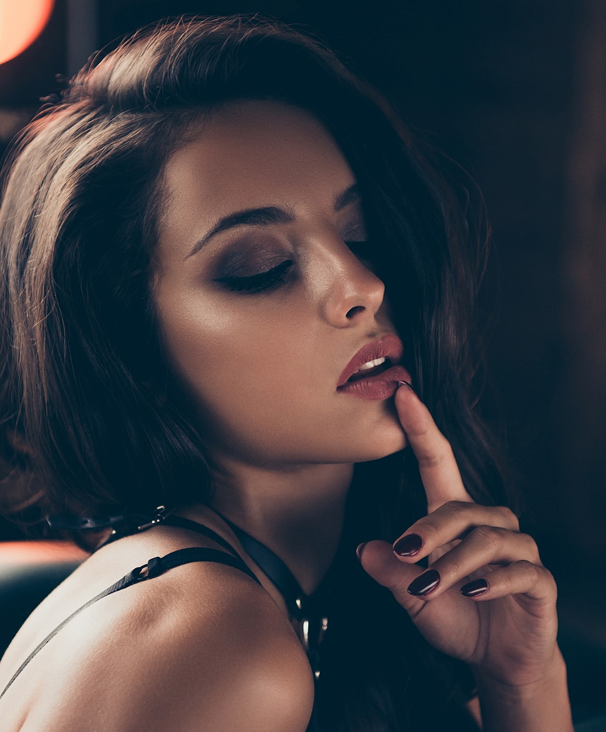 Woman with dark hair and sultry expression.